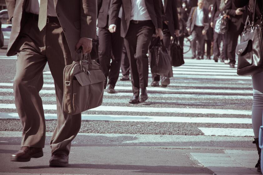 Low Section Of Business People Walking On Road
