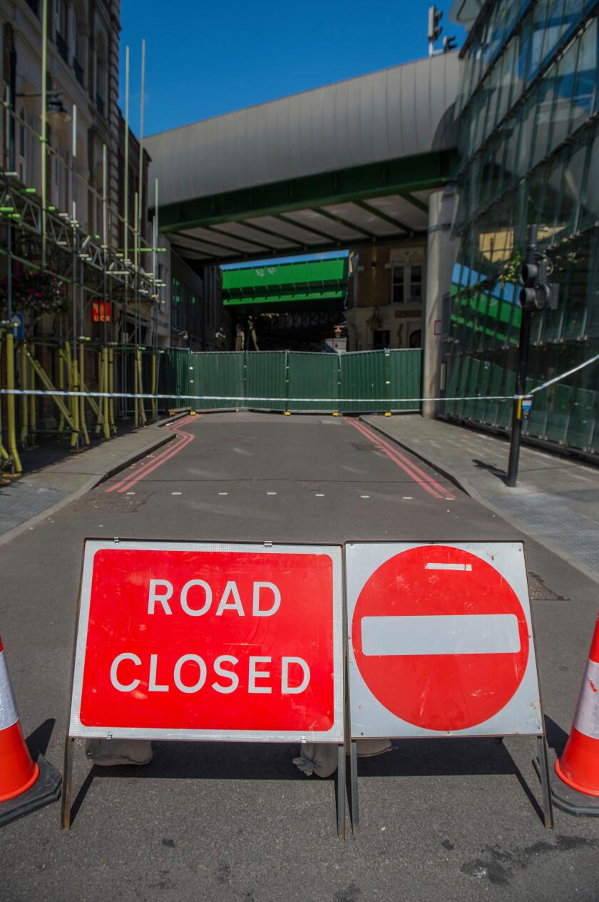 London, UK. 10th June, 2017. The market remains closed and the flag flies at half mast. But tourists still fill the London Bridge area - some pause for thought and others have left flowers. The market is still sealed off for investigation one week on. Lon