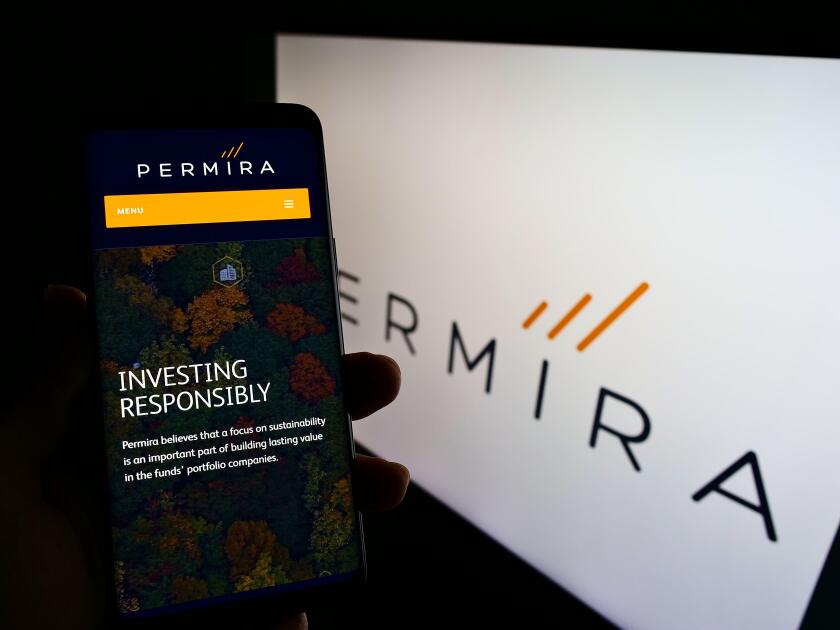 Person holding cellphone with website of British investment company Permira Holdings Limited on screen with logo. Focus on center of phone display.