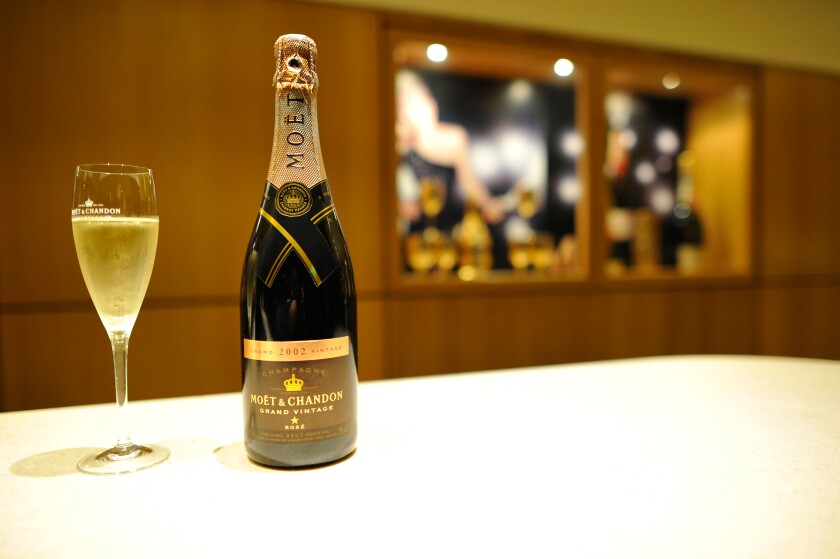 Champagne glass and champagne bottle, Grand Vintage Rose, Moet et Chandon winery, LVMH luxury goods group