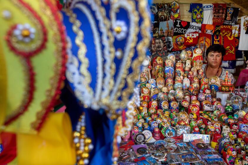 Russian Kokoshnik and Matreshka dolls in a range on a counter of a souvenir shop on Red Square in Moscow center, Russia