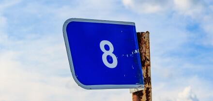 Kilometer blue sign on a pole with the number eight