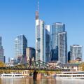 Frankfurt skyline skyscrapers with banks on River Main with bridge excursion boats in Frankfurt, Germany