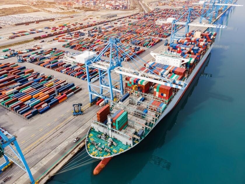 Container ship being loaded and unloaded at terminal freight port, international shipping and global commerce, modern cargo harbor and yard for mariti