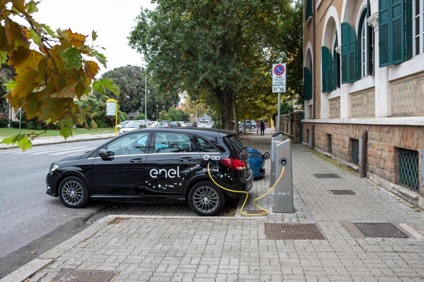 Electric Mercedes-Benz of E-Go car share service recharging on Enel X charging station in Ostia, a neighbourhood of Rome.