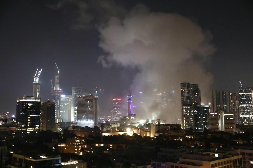 (250613) -- TEL AVIV, June 13, 2025 (Xinhua) -- Smoke rises following an Iranian missile attack in Tel Aviv, Israel, on June 13, 2025. Dozens of missiles were fired from Iran into Israel on Friday evening, according to statements issued by the Israel Defe