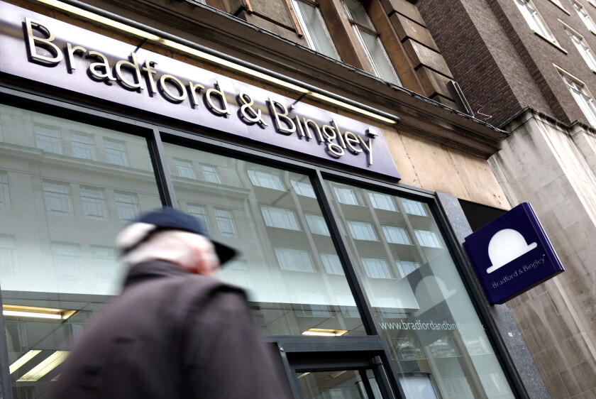 Commuters pass by a branch of Bradford & Bingley in central London, United Kingdom in 2009.