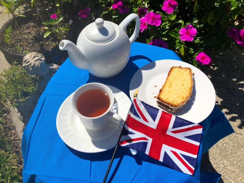 A small table set for tea for one with cake and the Union Jack