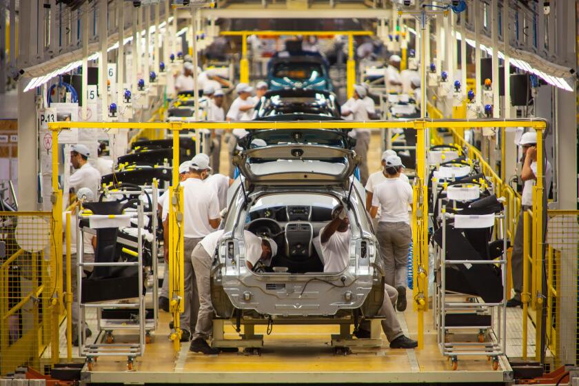 Automobile industry blue collar workers - Assembly line at Nissan Resende factory in Brazil.