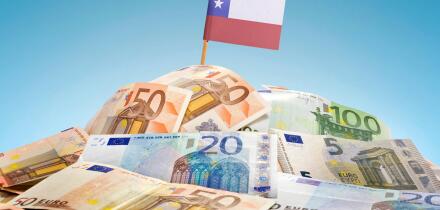The national flag of Chile sticking in a pile of mixed european banknotes.(series)