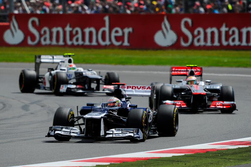 08.07.2012 Towcester, England. Pastor Maldonado of Venezuela and Williams F1 Team and Lewis Hamilton of Britain and Vodafone McLaren Mercedes in action during the Race at the Santander British Grand Prix, Round 9 of the 2012 FIA Formula 1 World Championsh