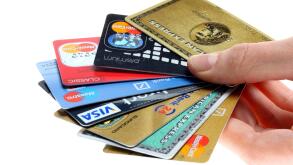 Hand holding a fan of of credit cards, bank cards