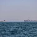 A container ship, right, and a cargo vessel are seen in the Strait of Hormuz off Bandar Abbas, Iran, Wednesday, June 17, 2026. (Amirhosein Khorgooi/ISNA via AP)