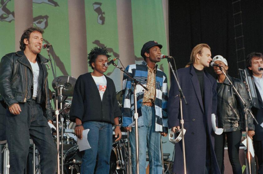 Rock stars, from left, Bruce Springsteen, Tracy Chapman, Youssou N'dour and Sting are seen at Wembley Stadium, London, Sept. 1, 1988, as they opened a global rock tour for human rights by Amnesty International. (AP Photo/John Redman)