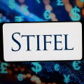 In this photo illustration, the logo of US investment company Stifel Financial Corp. is displayed on a smartphone in front of abstract background on computer screen. (Photo by Timon Schneider / SOPA Images/Sipa USA) *** Strictly for editorial news purpose