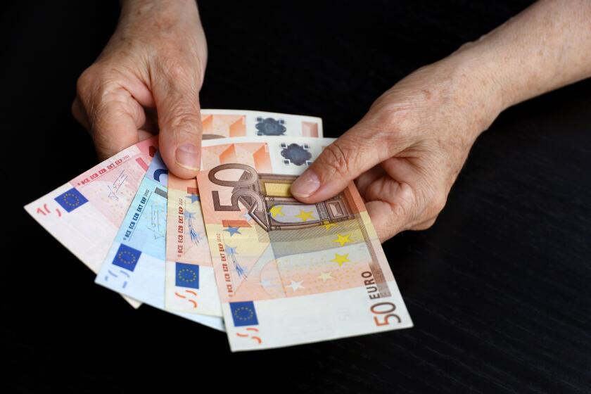 Elderly woman with euro notes in wrinkled hands. Concept of pension payments, savings at retirement, pensioner with money