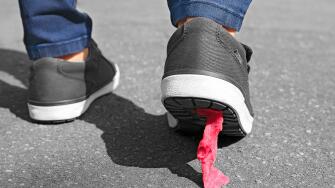 Foot stuck into chewing gum on street