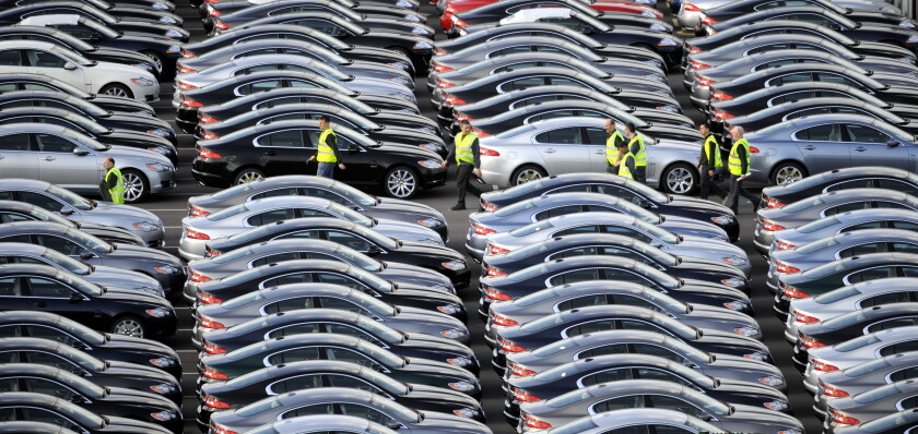 A WORKER WALKS AMONGST BRAND NEW JAGUAR CARS AT THE CAR COMPANYS FACTORY AT CASTLE BROMWICH,BIRMINGHAM ,UK.