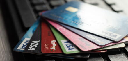 Selective focus on a group of credit and debit cards placed on a computer keyboard