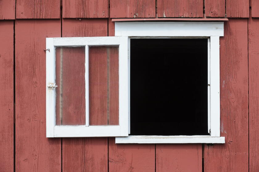 Open window in red barn with white trim as a design element, place your own image in the opening.