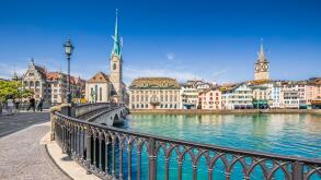 Historic city center of Zurich with famous Fraumunster Church and Munsterbucke crossing river Limmat, Canton of Zurich, Switzerland