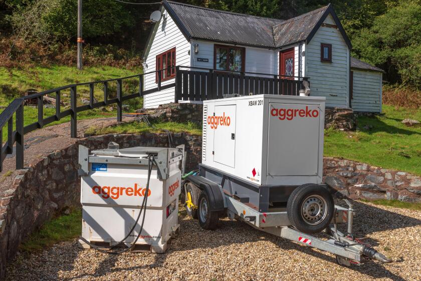 Aggreko Mobile diesel electricity generator on site in a remote countryside location.