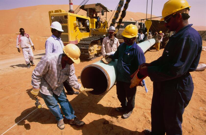 Laying pipeline in the remote Shaybah oil field in the empty quarter of Saudi Arabia to connect with the Dhahran facility.