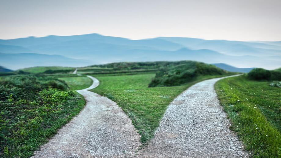 landscape of a fork in the road at storm weather, concept of insecurity of future