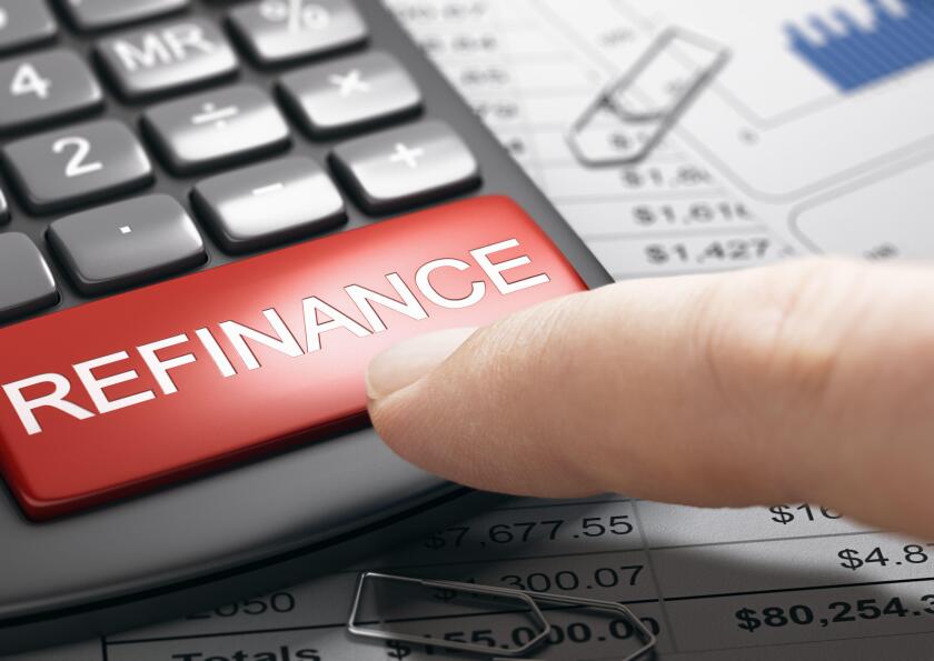 Finger about to press a red button on a conceptual refinance calculator. Concept of bad credit repair. Composite image between a hand photography and