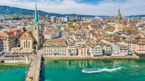 Aerial view of Zurich city center with famous Fraumunster and Sankt Peter Churches and river Limmat at Lake Zurich seen from Grossmunster, Switzerland