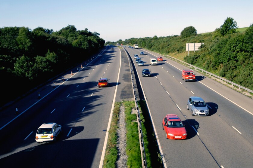 Traffic in the early morning light on the M4 in South Wales UK GB