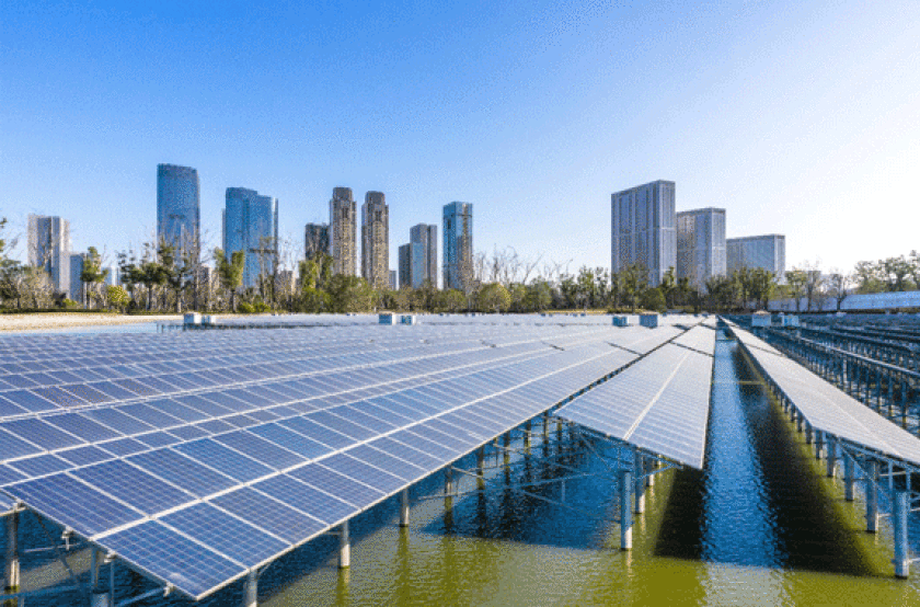 solar panels in water with cityscape in background