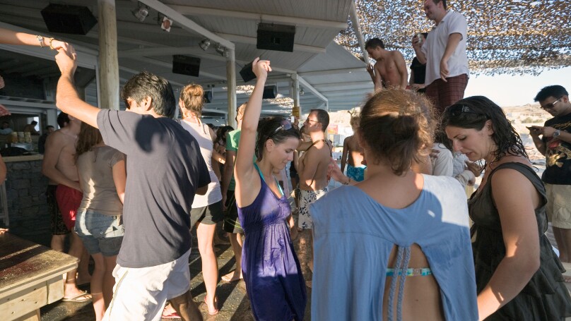 Mykonos, Greece. Tourists dancing at the Tropicana Club on Paradise Beach