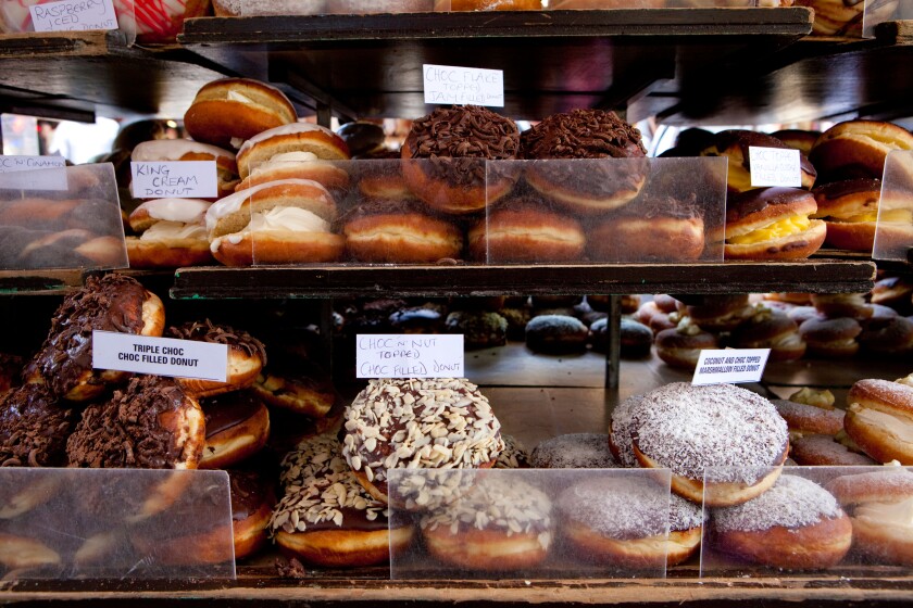 Doughnuts for sale on a market stall in Campden, London.. Image shot 04/2009. Exact date unknown.