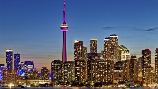 CN Tower dominates skyline of Harbourfront and Downtown Toronto, viewed from Wards Island.