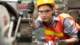 Female Engineers operating a cnc machine in factory
