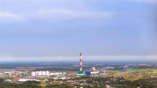 View from heights of Tallinn TV tower on Iru power plant, Eesti Energia. Types and horizons of Baltic cities with altitude. Cloudy overcast sky and ha