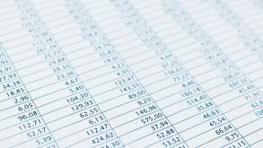 Business data report selective focus close up. Monthly stock stats spreadsheet. Blue toned.