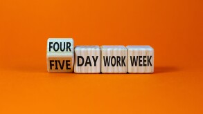 4 or 5 day work week symbol. Turned the cube and changed words 'five day work week' to 'four day work week'. Beautiful orange background. Copy space. Business and 4 or 5 day work week concept.