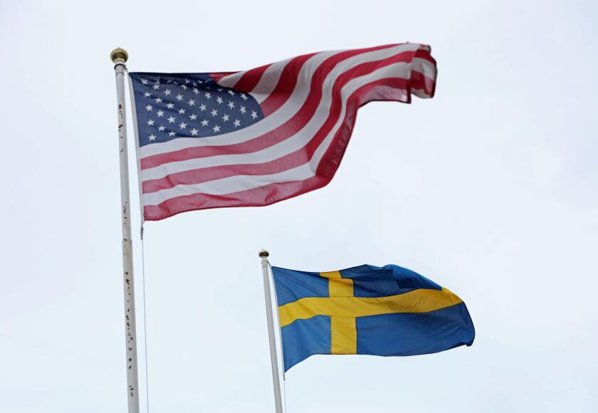 The Swedish flag and the US flag in Stockholm, Sweden, during Sunday afternoon.