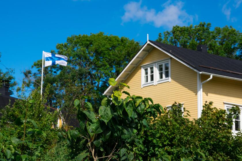 Helsinki, Finland. August 26, 2017. Yellow house and Flag of Finland in Suomenlinna (Sveaborg) Fortress