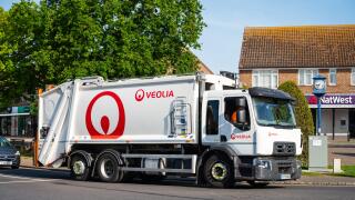 Veolia waste management vehicle, truck, lorry or dust cart on a road in England, UK.
