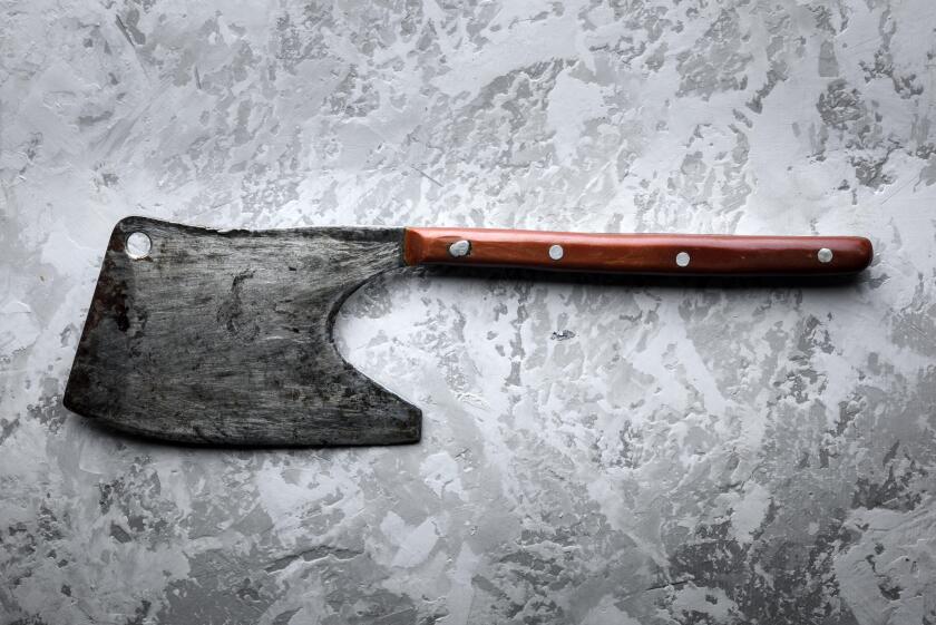 Old rustic axe for meat on grunge background