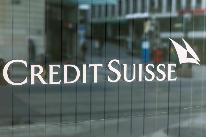 The logo of the Credit Suisse bank is written on the window of the bank in Bel-air Square in Geneva, Switzerland.