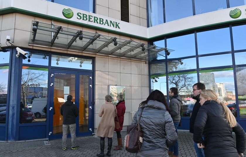 Brno, Cr . 25th Feb, 2022. People stand in a queue in front of the branch of Sberbank CZ, which has links to Russia, in Brno, Czech Republic, February 25, 2022. Bank closed its branches in Czechia at 14:00, bank spokeswoman Radka Cerna told CTK, citing se
