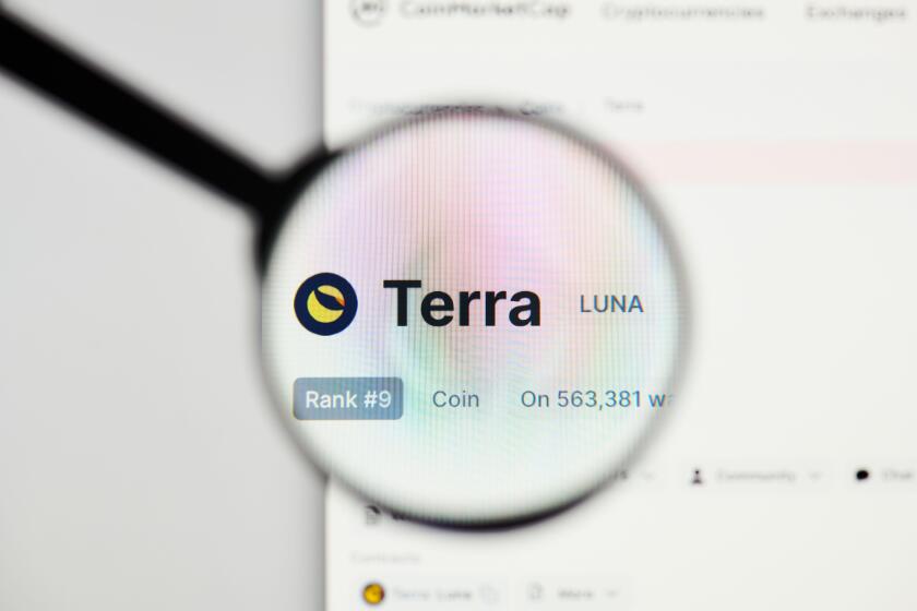 Milan, Italy - January 11, 2022: terra - LUNA website's hp.  terra, LUNA coin logo visible through a loope. Defi, ntf, cryptocurrency concepts illustr