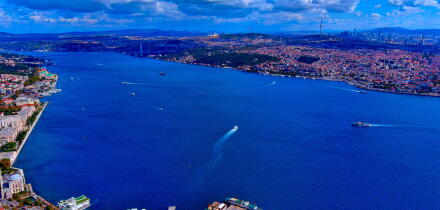 Aerial drone view of Bosphorus Strait with Dolmabahce Palace waterfront, ferries crossing between Europe and Asia, Istanbul, Turkey