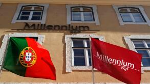 The Millennium BCP flag and the Portugal's flag are seen at the bank headquarters in Lisbon February 3, 2012. The largest listed banks by assets, Millennium BCP, should post a net loss of between 560 millions euros ($739 million) and 954 million, accordin