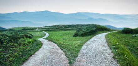 landscape of a fork in the road at storm weather, concept of insecurity of future