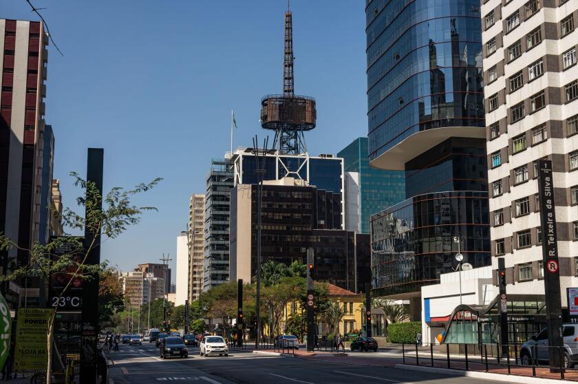Itau Cultural building with his iconic communication tower on top surrounded by many commercial buildings and office complexes at Paulista Avenue.